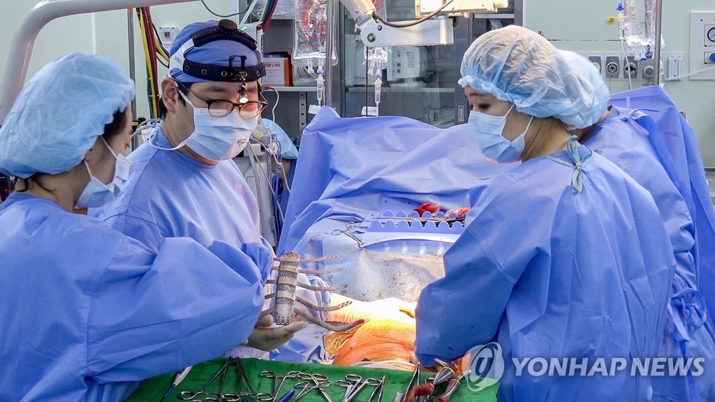 This Yonhap file photo shows doctors implanting an artificial chest based on 3D printing technology. (Yonhap)