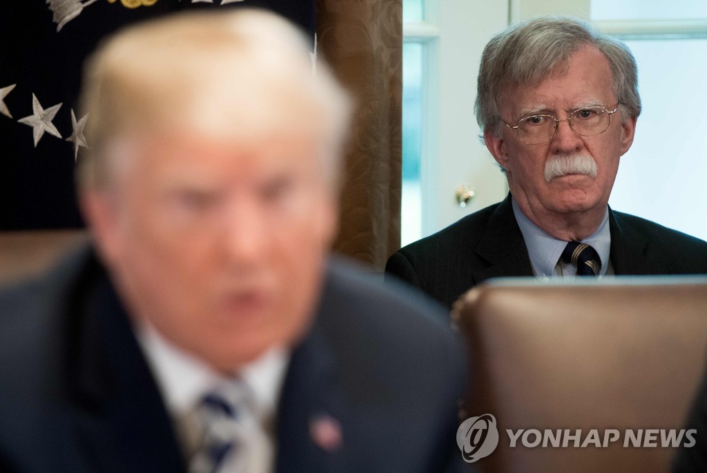 This AFP photo shows then U.S. National Security Adviser John Bolton looking on as President Donald Trump speaks during a Cabinet meeting at the White House on May 9, 2018. (Yonhap)