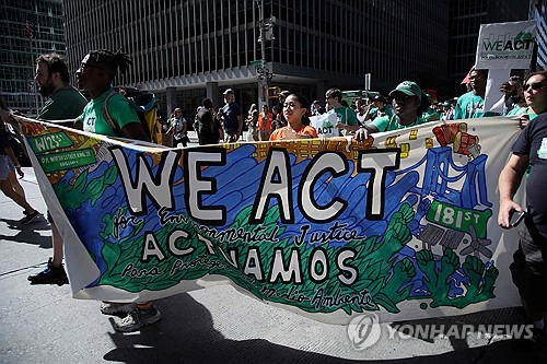 This photo, distributed by the AFP, shows environmentalists staging a rally in New York on Sept. 17, 2023. (Yonhap)