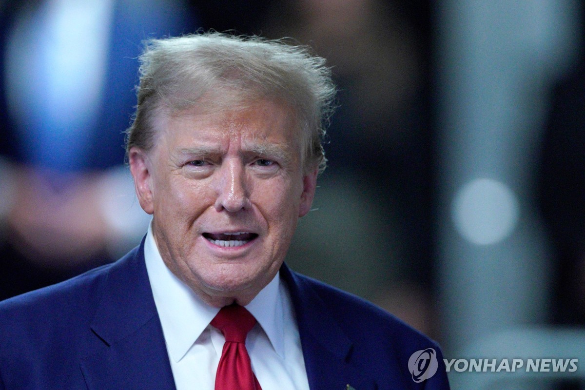 Former US President Donald Trump speaks to the press before departing for the day at his trial for allegedly covering up hush money payments linked to extramarital affairs, at Manhattan Criminal Court in New York City on April 30, 2024 in this photo released by AFP. (Yonhap)