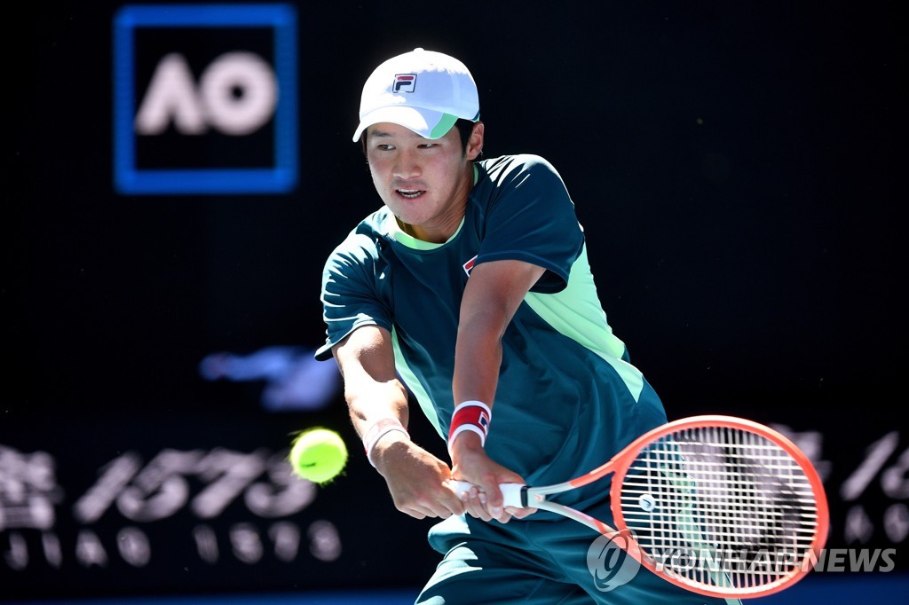 In this EPA photo, Kwon Soon-woo of South Korea hits a return to Denis Shapovalov of Canada during their second round men's singles match of the Australian Open at Margaret Court Arena in Melbourne on Jan. 19, 2022. (Yonhap)