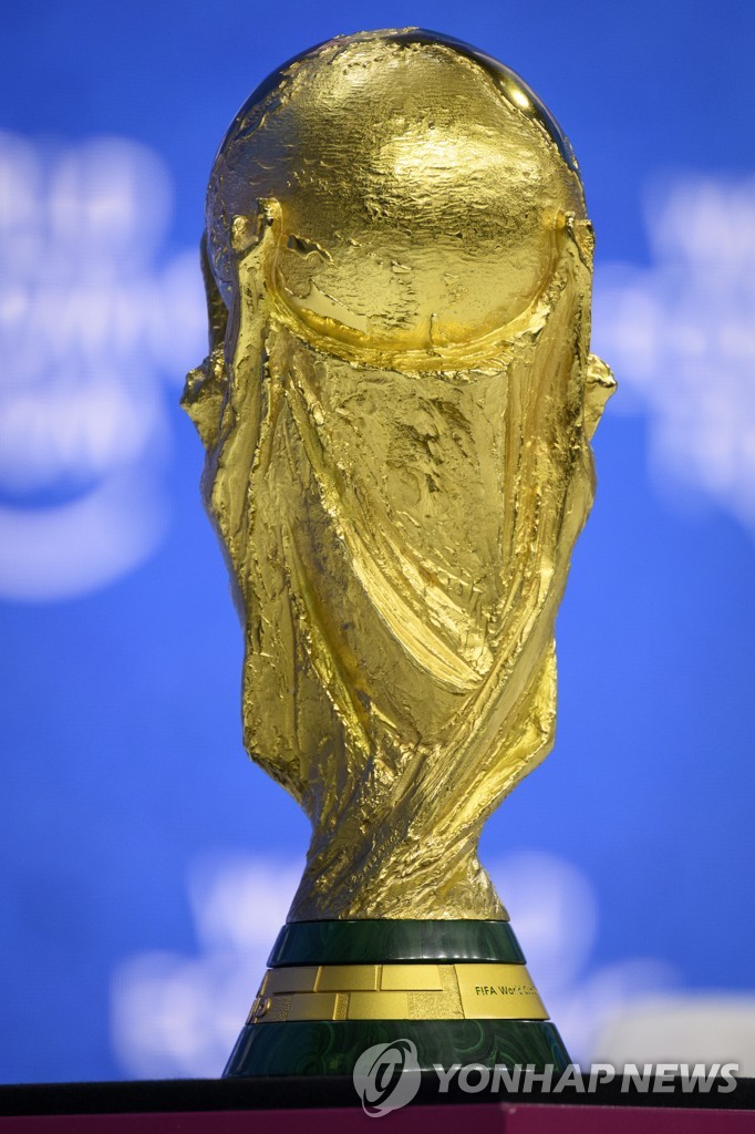 This EPA file photo from May 23, 2022, shows the winner's trophy for the 2022 FIFA World Cup in Qatar on display during the World Economic Forum meeting in Davos, Switzerland. (Yonhap)
