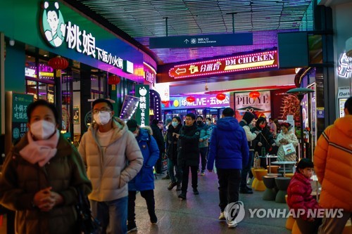 중국 베이징의 쇼핑가를 지나는 시민들