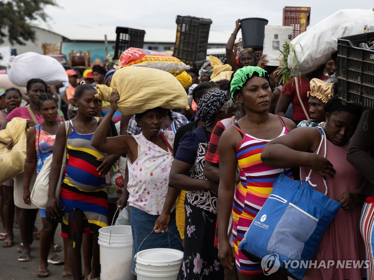 식료품 구입 후 국경을 넘기 위해 대기 중인 아이티 주민들