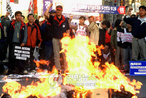 2000년 10월 전태열 열사 30주기 추모기념식에서 근로기준법 화형식을 진행하는 노동자들