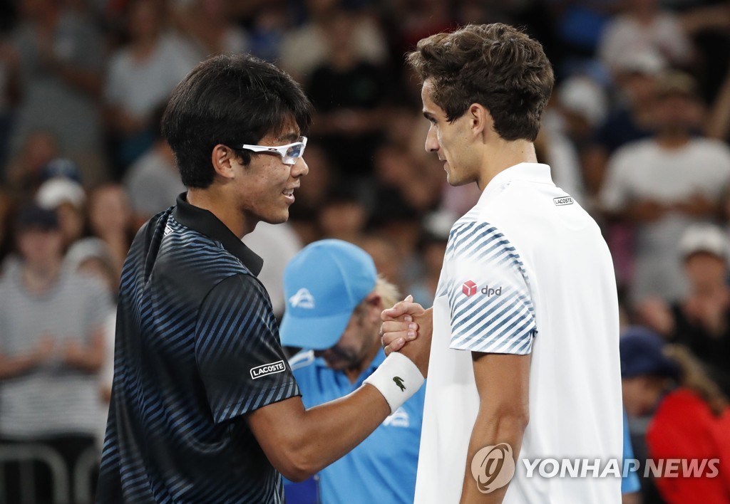 In this Reuters photo, Chung Hyeon of South Korea (L) and Pierre-Hugues Herbert of France shake hands after their second-round match in the men's singles at the Australian Open at Melbourne Arena in Melbourne on Jan. 17, 2019. (Yonhap)