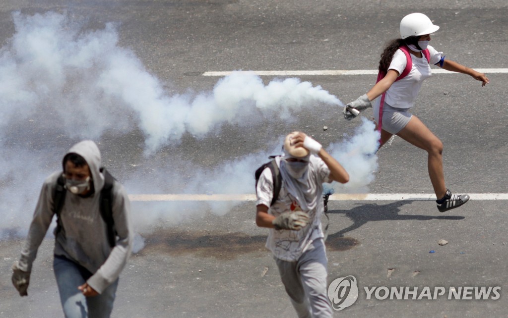 최루탄을 되던지는 반정부 시위자 [로이터=연합뉴스] 