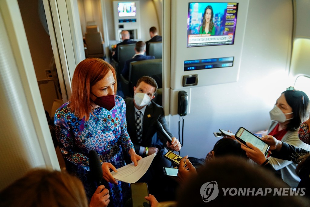 This Reuters photo shows White House Press Secretary Jen Psaki (L, standing) speaking to reporters aboard Air Force One en route to Philadelphia on April 30, 2021. (Yonhap)