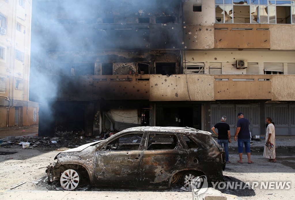 리비아 양대 정부 후원세력간 무력충돌로 불에 타고 부서진 트리폴리 시내 건물과 차량.