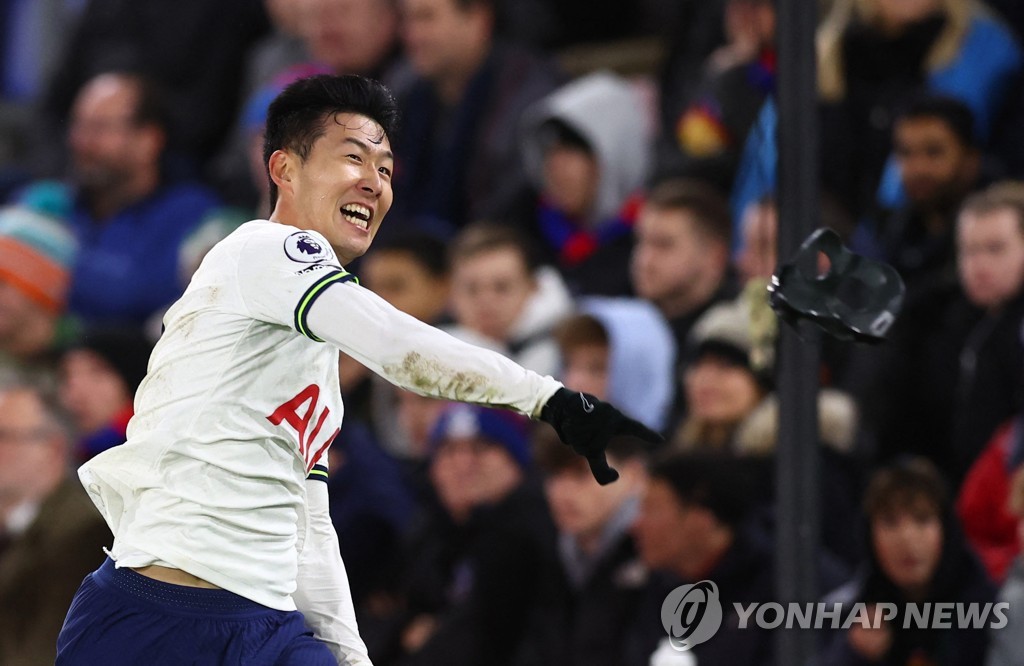 In this Reuters photo, Son Heung-min of Tottenham Hotspur throws away his mask to celebrate his goal against Crystal Palace during the clubs' Premier League match at Selhurst Park in London on Jan. 4, 2023. (Yonhap)