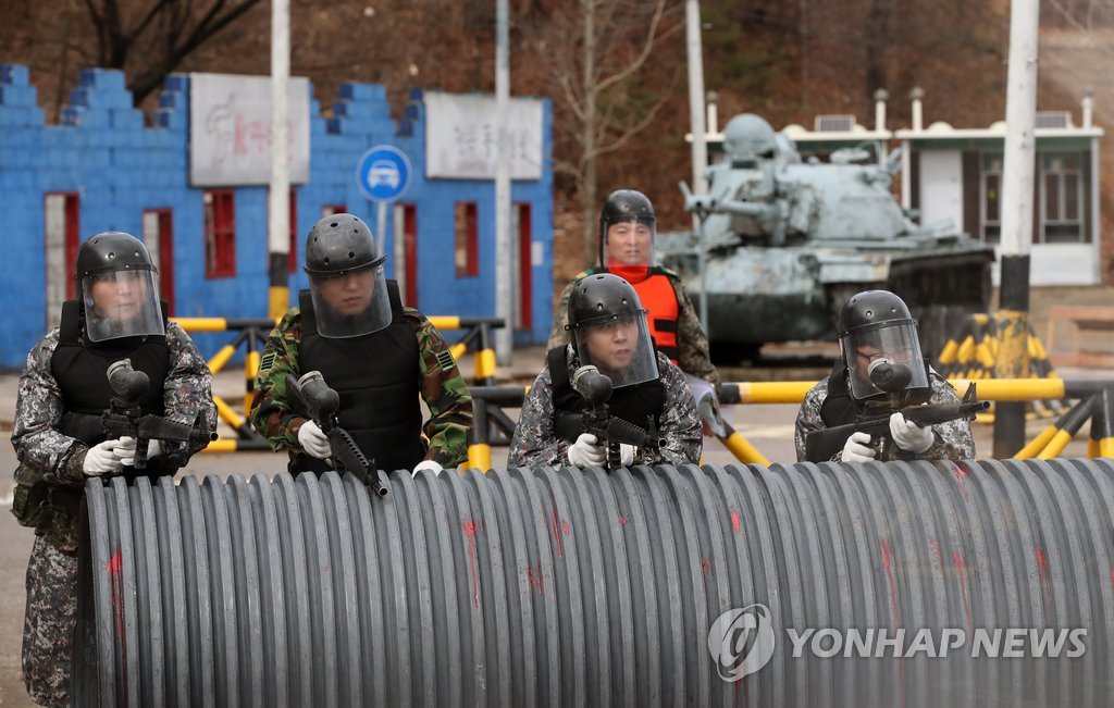 In this file photo, taken on March 5, 2018, members of the reserve forces engage in a street fighting drill at an Army unit in Seoul's Songpa Ward after they were mobilized to participate in the year's first mandatory exercise. (Yonhap)
