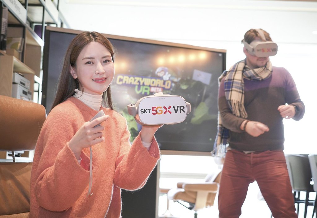 This photo provided by SK Telecom Co. on Feb. 13, 2020, shows models presenting the virtual reality game "Crazy World VR." (PHOTO NOT FOR SALE) (Yonhap)