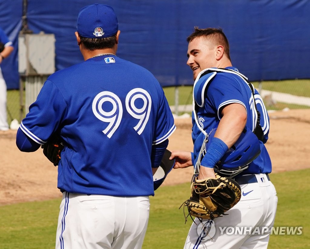 Toronto Blue Jays' pitcher Ryu Hyun-jin (L) and catcher Reese McGuire talk to each other after their bullpen session at a facility outside TD Ballpark in Dunedin, Florida, on Feb. 13, 2020. (Yonhap)