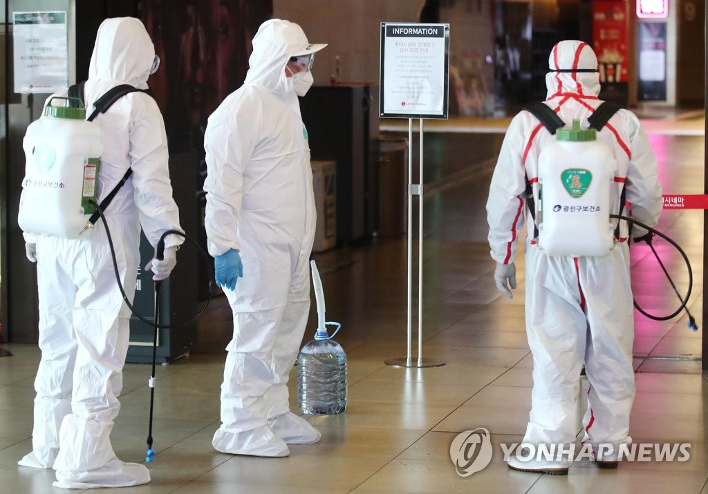 Seoul public health workers disinfect Lotte Cinema cineplex near Konkuk University in Seoul on Feb. 26, 2020. (Yonhap)