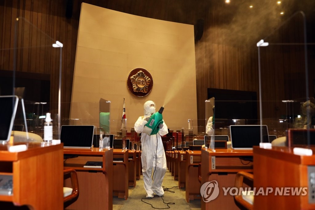 Workers disinfect the main hall at the National Assembly in western Seoul on Sept. 3, 2020, in this photo released by parliament. (PHOTO NOT FOR SALE) (Yonhap)