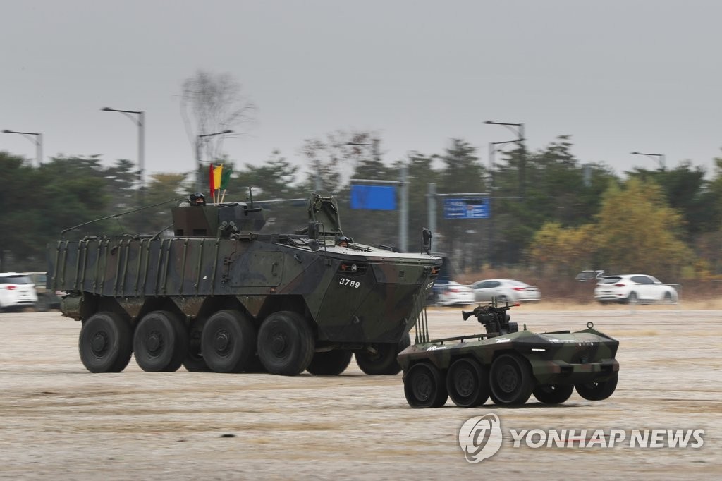 In this file photo, taken Nov. 18, 2020, an armored vehicle and an unmanned combat robot take part in a joint operation in a demonstration at the Defense and Security (DX) Korea 2020, an international defense industry fair, at an exhibition center in Ilsan, north of Seoul. (Yonhap) 