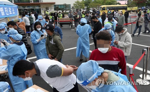 新型コロナウイルスの臨時診療所で検査の順番を待つ外国人労働者（資料写真）＝（聯合ニュース）