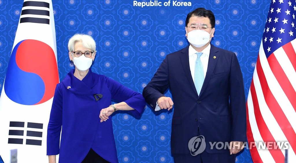 First Vice Foreign Minister Choi Jong-kun (R) and U.S. Deputy Secretary of State Wendy Sherman elbow bump each other before their talks at the foreign ministry in Seoul on July 23, 2021, in this photo provided by the ministry. (PHOTO NOT FOR SALE) (Yonhap)