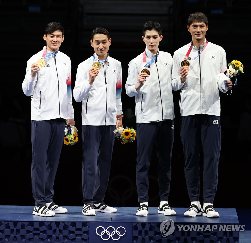 South Korean fencers Gu Bon-gil, Kim Jung-hwan, Kim Jun-ho and Oh Sang-uk (L to R) pose with their gold medals from the men's team sabre fencing event at the Tokyo Olympics at Makuhari Messe Hall B in Chiba, Japan, on July 28, 2021. (Yonhap)