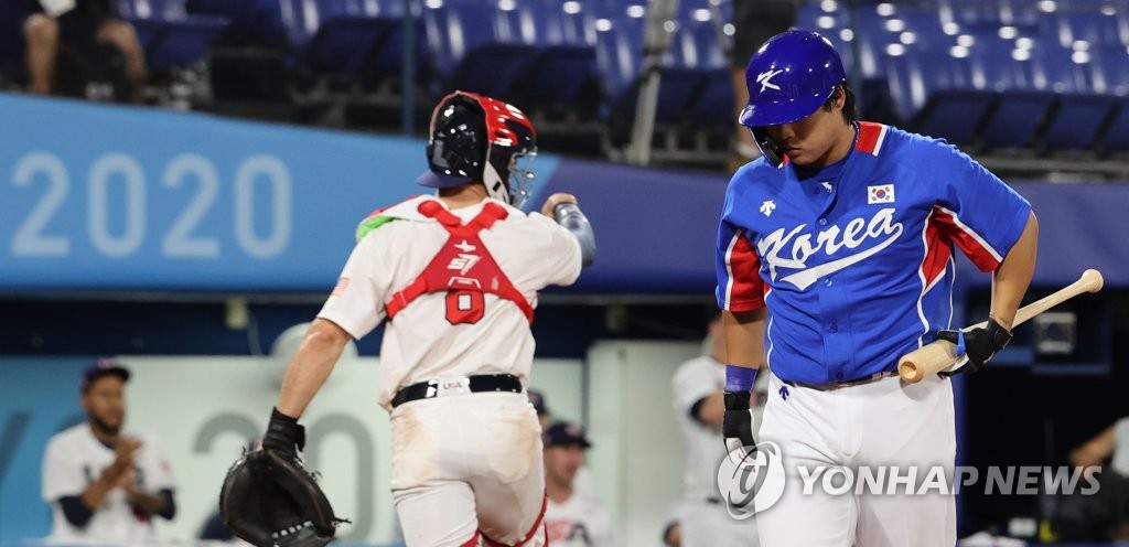 Kang Baek-ho of South Korea (R) returns to the dugout after striking out against the United States in the top of the sixth inning of the teams' Group B game in the Tokyo Olympic baseball tournament at Yokohama Stadium in Yokohama, Japan, on July 31, 2021. (Yonhap)