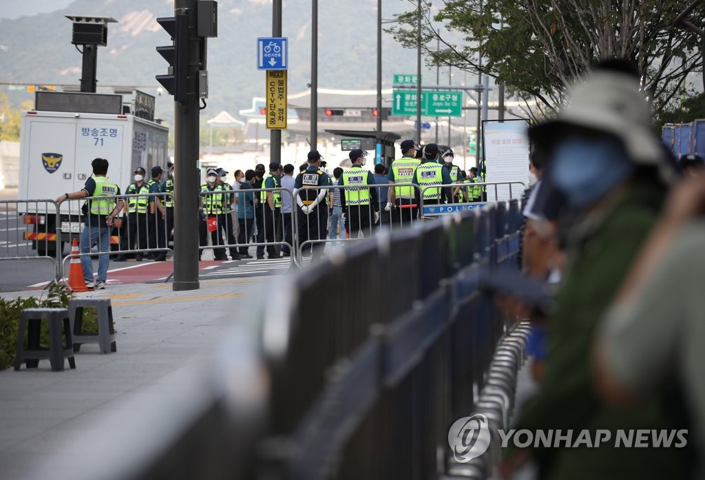 Police officers are on standby with fences set up along the main streets in Seoul's central Gwanghwamun, ahead of a planned demonstration by a doctors' association critical of the government's COVID-19 policies, on Oct. 3, 2021. The medical association won court approval to hold the rally in a scaled-down manner, as the court suspended the Seoul city government's ban on the event.