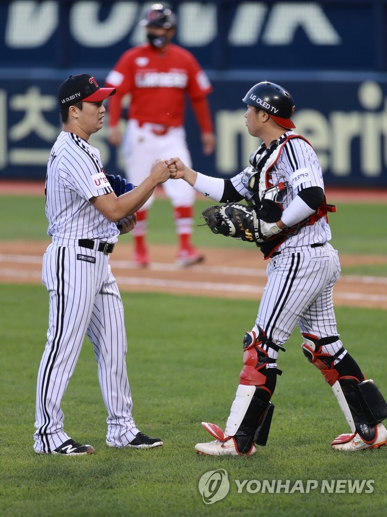 In this file photo from Oct. 6, 2021, Go Woo-suk of the LG Twins (L) bumps fists with his catcher Yoo Kang-nam after closing out a 4-1 victory over the SSG Landers in a Korea Baseball Organization regular season game at Jamsil Baseball Stadium in Seoul. (Yonhap)