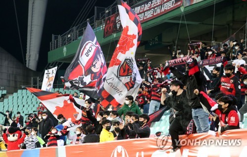 FC Pohang Steelers' Lee Seung-mo, left, celebrates after scoring