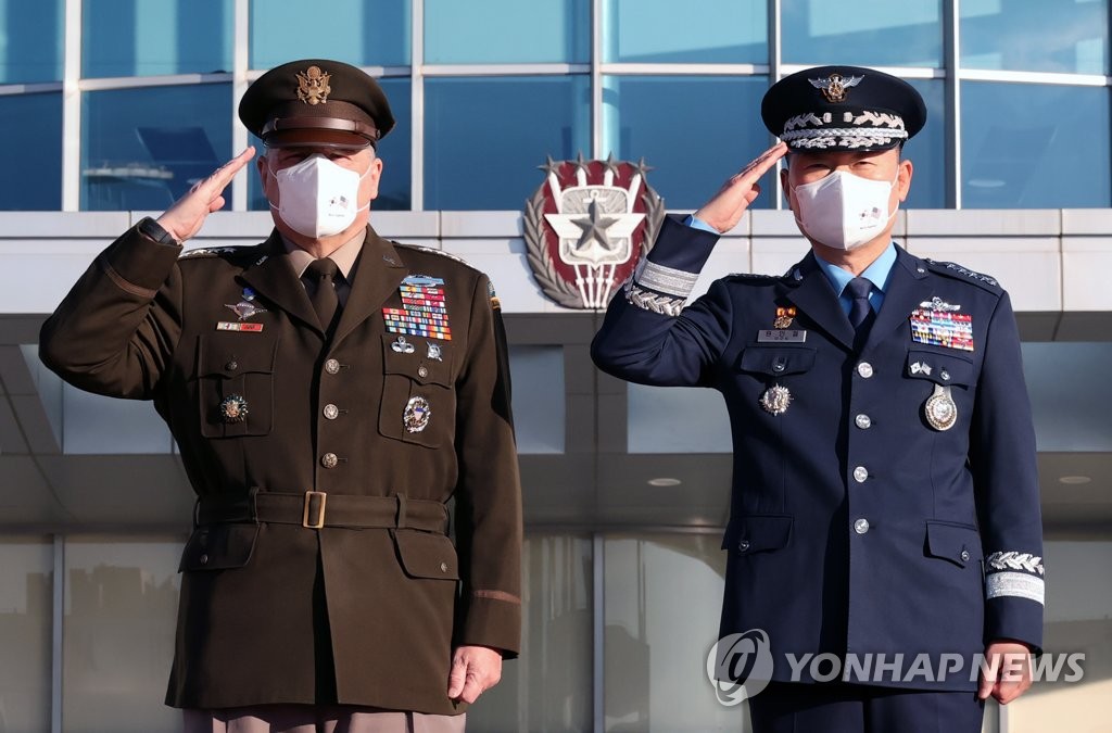 South Korea's Joint Chiefs of Staff Chairman Gen. Won In-choul (R) and his U.S. counterpart, Gen. Mark A. Milley, salute as they review an honor guard ahead of their talks at the JCS in Seoul on Dec. 1, 2021. (Pool photo) (Yonhap)