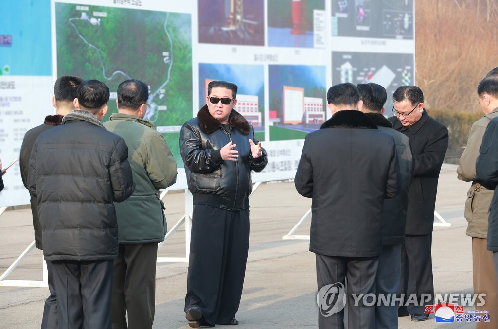 North Korean leader Kim Jong-un (C) talks with officials during a visit to the Sohae Satellite Launching Ground in Cholsan, North Pyongan Province, in this undated photo released on March 11, 2022, by the North's official Korean Central News Agency. Kim's visit to the satellite test site on the west coast came as Seoul and Washington jointly concluded Pyongyang's recent purported "reconnaissance satellite" development tests were those of a new intercontinental ballistic missile system. (For Use Only in the Republic of Korea. No Redistribution) (Yonhap)