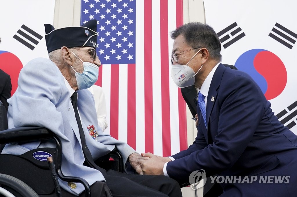 South Korean President Moon Jae-in (R) meets with retired U.S. Army Col. William E. Weber, a highly decorated Korean War veteran, at a groundbreaking ceremony to construct the Wall of Remembrance at the Korean War Veterans Memorial in Washington, in this photo dated May 22, 2021, and released by the presidential office. (PHOTO NOT FOR SALE) (Yonhap)