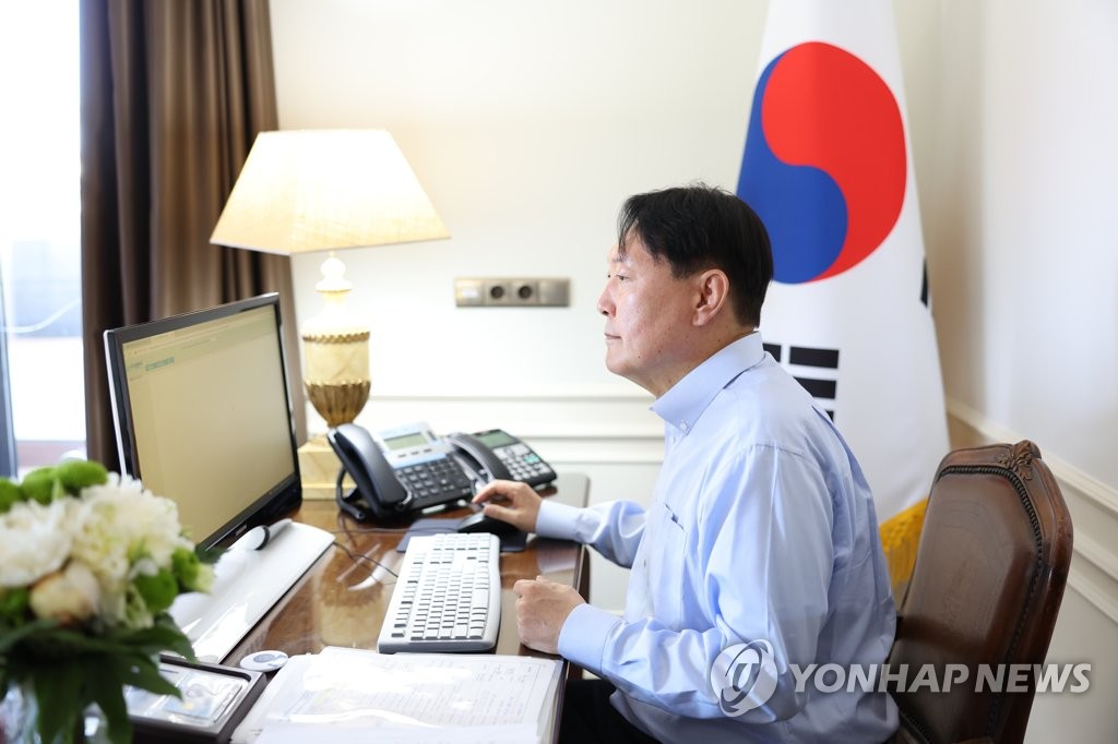 This photo, provided by the presidential office, shows President Yoon Suk-yeol looking at a computer monitor at his hotel in Madrid on June 28, 2022. (PHOTO NOT FOR SALE) (Yonhap)