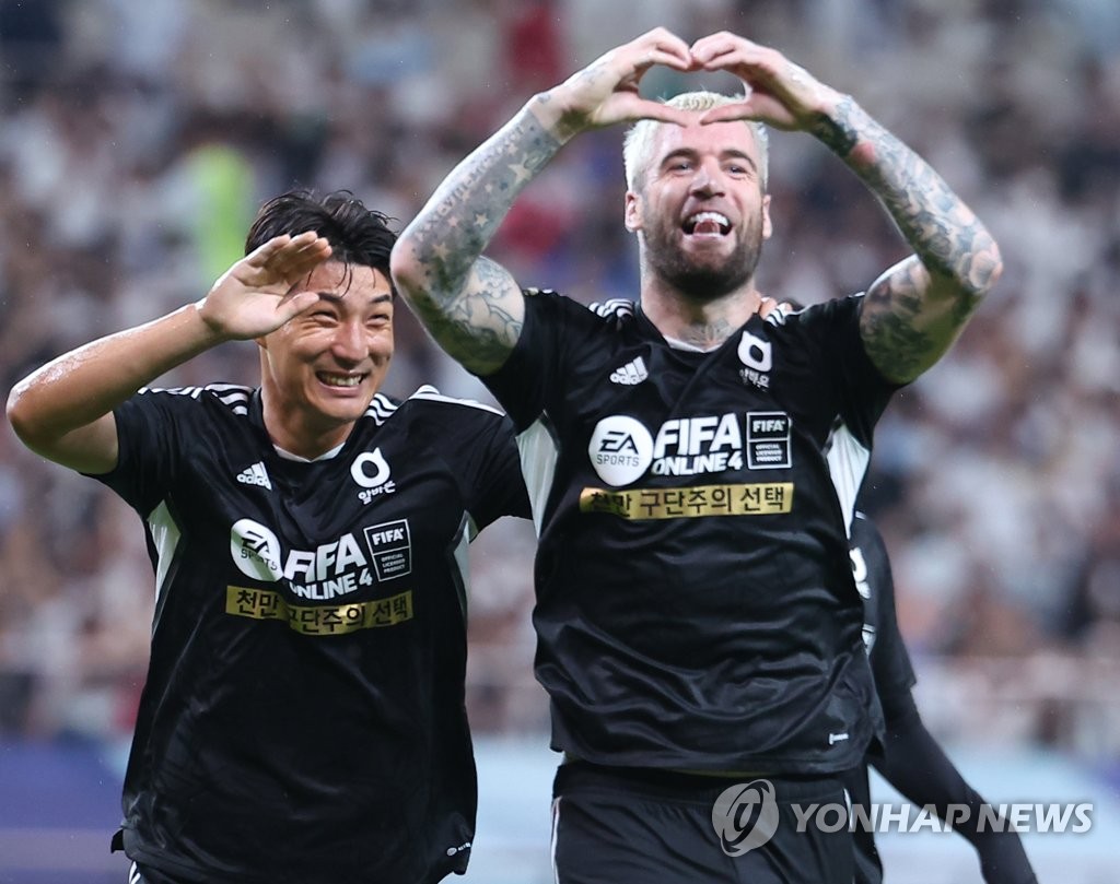 Lars Veldwijk (R) and Joo Min-kyu of Team K League celebrate Veldwijk's goal against Tottenham Hotspur during the teams' exhibition match at Seoul World Cup Stadium in Seoul on July 13, 2022. (Yonhap)