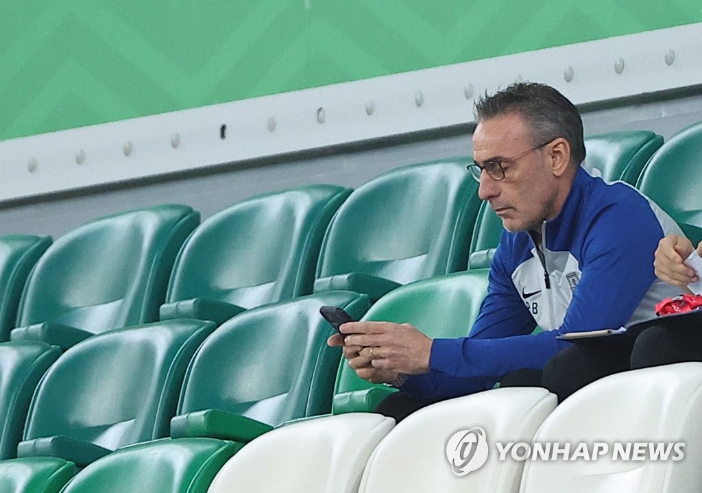 South Korea head coach Paulo Bento waits for the start of his team's Group H match against Portugal at the FIFA World Cup in the VIP section at Education City Stadium in Al Rayyan, west of Doha, on Dec. 2, 2022. Bento was suspended for this match. (Yonhap)