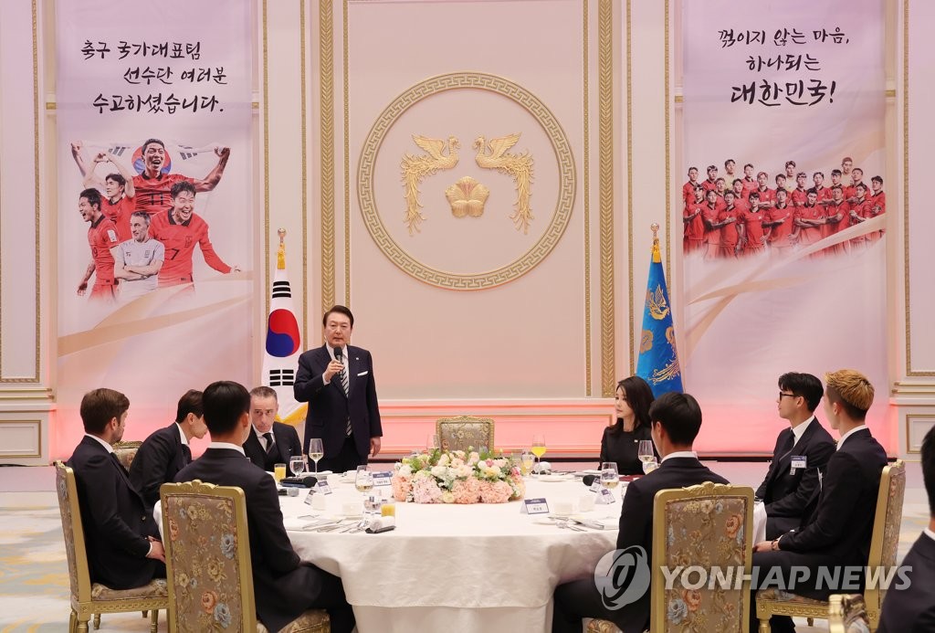 El presidente de Corea del Sur, Yoon Suk-yeol (de pie), pronuncia un discurso, el 8 de diciembre de 2022, durante una cena para el equipo nacional de fútbol de Corea del Sur para la Copa Mundial 2022, en la antigua oficina presidencial, Cheong Wa Dae, en el centro de Seúl.