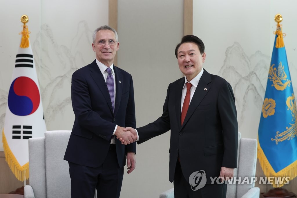 South Korean President Yoon Suk Yeol (R) and North Atlantic Treaty Organization Secretary General Jens Stoltenberg pose for a photo during their meeting at the presidential office in Seoul on Jan. 30, 2023, in this photo provided by the office. (PHOTO NOT FOR SALE) (Yonhap)