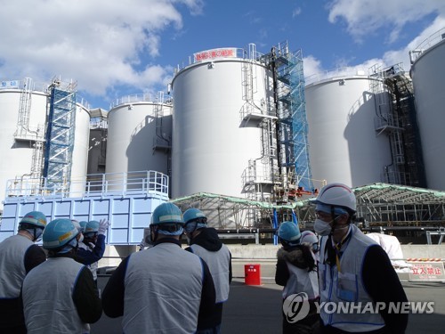In this file photo, officials at the Tokyo Electric Power Co., the operator of the crippled Fukushima nuclear plant, speak to journalists at Fukushima Daiichi Nuclear Power Station on Feb. 2, 2023. (Yonhap)