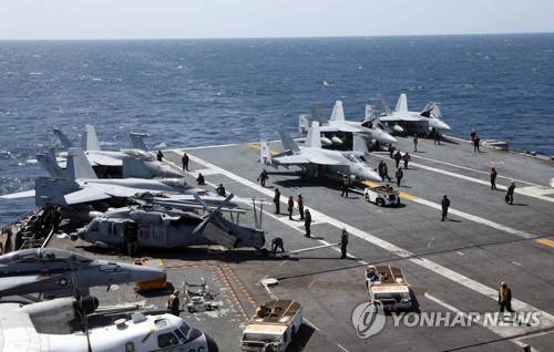This photo, taken on March 27, 2022, shows the flight deck of the USS Nimitz aircraft carrier engaging in drills with the South Korean Navy in waters south of the Korean Peninsula. (Pool photo) (Yonhap)