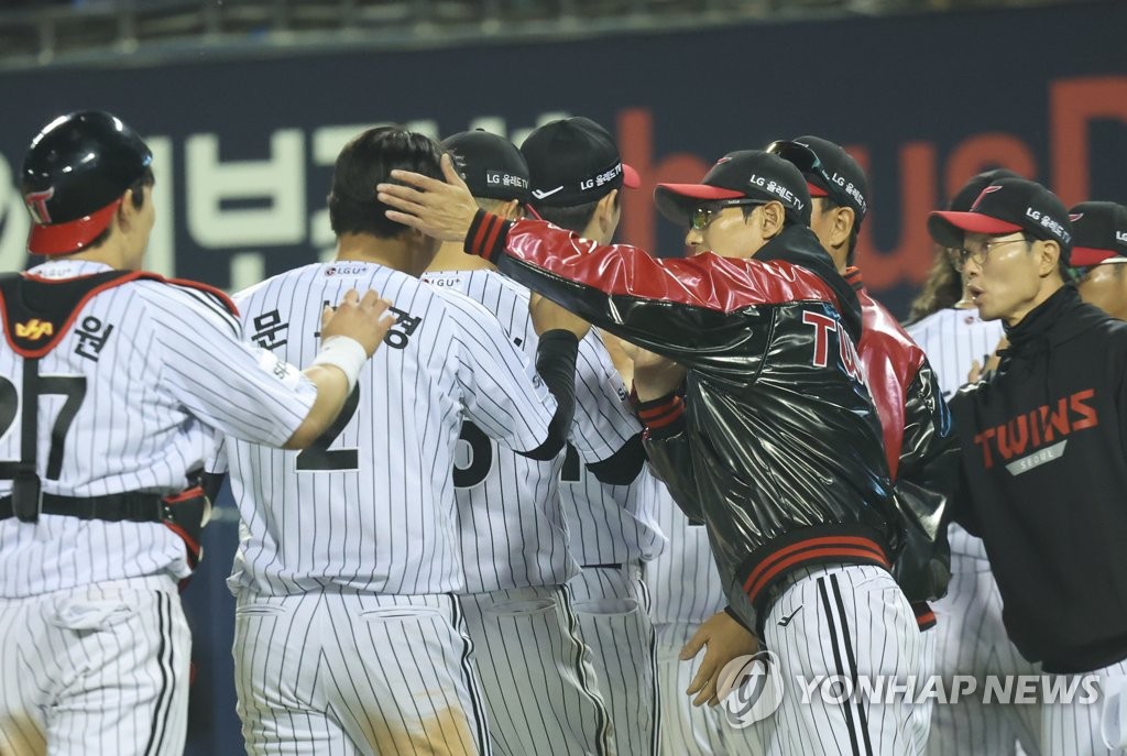 LG Twins manager Youm Kyoung-youb (R) pats infielder Moon Bo-gyeong on the head after a 7-5 victory over the NC Dinos in a Korea Baseball Organization regular season game at Jamsil Baseball Stadium in Seoul on April 19, 2023. (Yonhap)