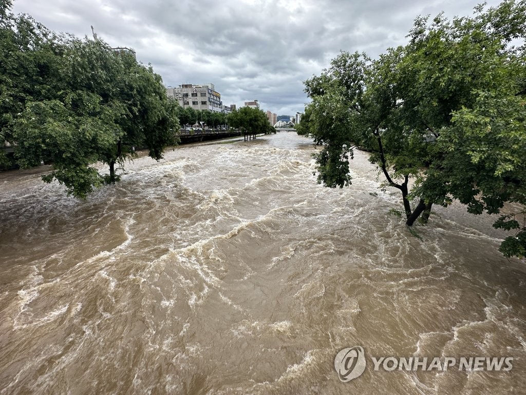 The Gwangju Stream in the southwestern city of Gwangju is flooded due to heavy rains on June 28, 2023. (Yonhap)