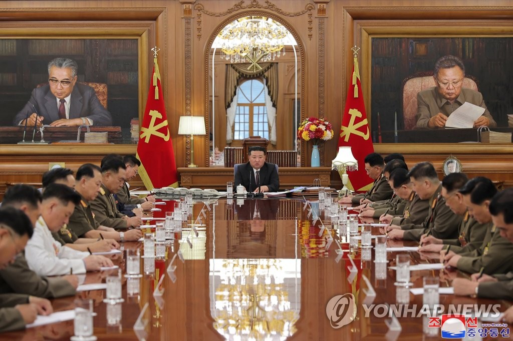 This photo, carried by the North's Korean Central News Agency on Aug. 10, 2023, shows North Korean leader Kim Jong-un (C) presiding over an enlarged meeting of the Central Military Commission of the ruling Workers' Party of Korea the previous day. (For Use Only in the Republic of Korea. No Redistribution) (Yonhap)
