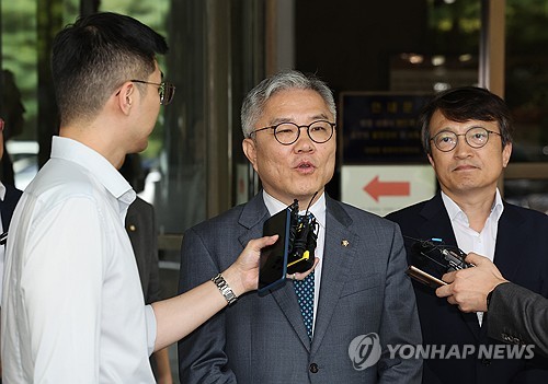 Rep. Choe Kang-wook (C) of the main opposition Democratic Party speaks to reporters outside the Supreme Court in Seoul on Sept. 18, 2023, after the court upheld a suspended prison term for him for fabricating an internship certificate for the son of former Justice Minister Cho Kuk. (Yonhap)