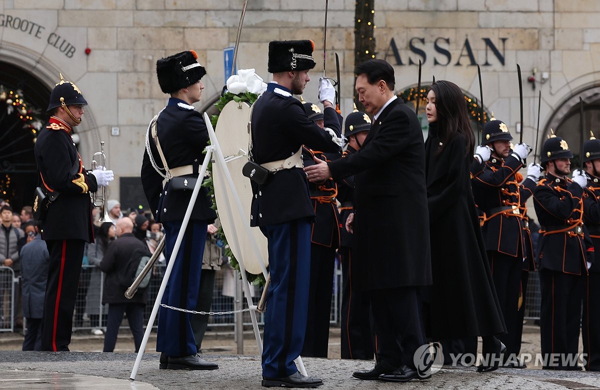 El presidente surcoreano, Yoon Suk Yeol (segundo por la derecha), rinde homenaje al Monumento Nacional en la Plaza Dam de Ámsterdam, Países Bajos, el 12 de diciembre de 2023. (Yonhap)