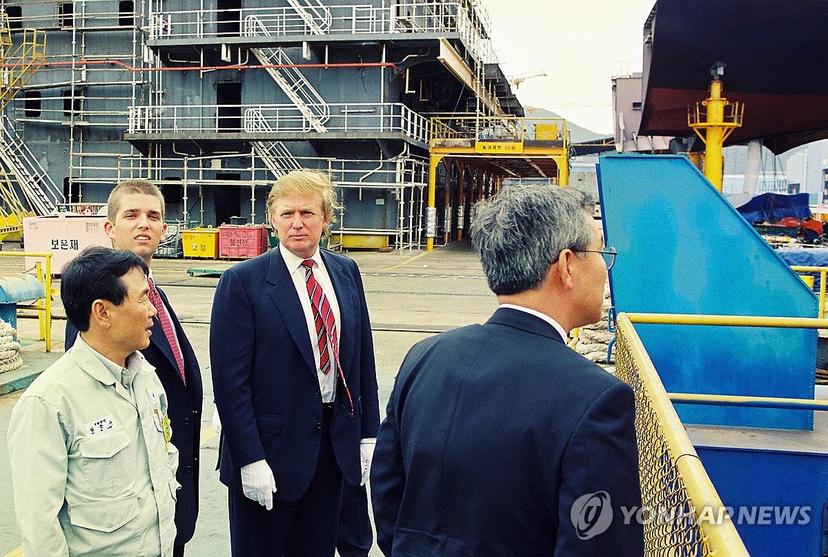 This photo, provided by Daewoo Shipbuilding & Marine Engineering (DSME) on Nov. 8, 2024, shows Donald Trump (2nd from R) and his eldest son, Donald Trump Jr. (L, rear), visiting the South Korean shipbuilder's Okpo Shipyard on Geoje Island, about 330 kilometers southeast of Seoul, on June 5, 1998. In a phone conversation with South Korean President Yoon Suk Yeol on Nov. 8, 2024, U.S. President-elect Donald Trump reportedly mentioned the United States seeks to collaborate with South Korea in the shipbuilding industry, particularly in naval shipbuilding, exports, repairs and maintenance. (PHOTO NOT FOR SALE) (Yonhap)